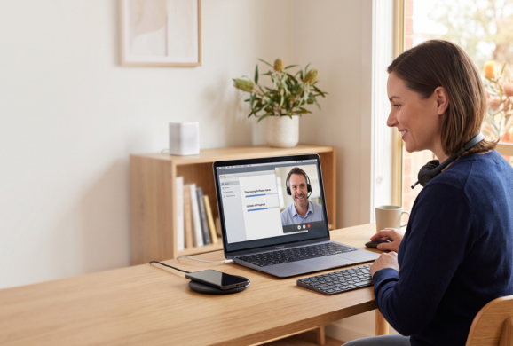Person on a video call at a home desk, receiving remote support
