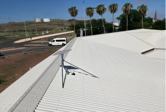 Starlink dish installed on a commercial roof overlooking a Karratha street
